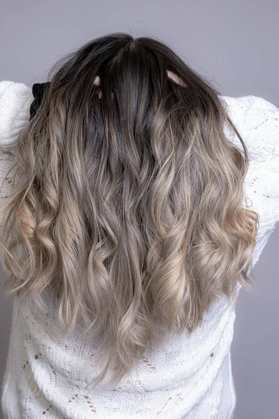 Soft ash-blonde waves falling past the shoulders